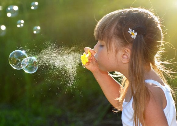 A little girl playing with a Bubble maker in Owings Mills, MD
